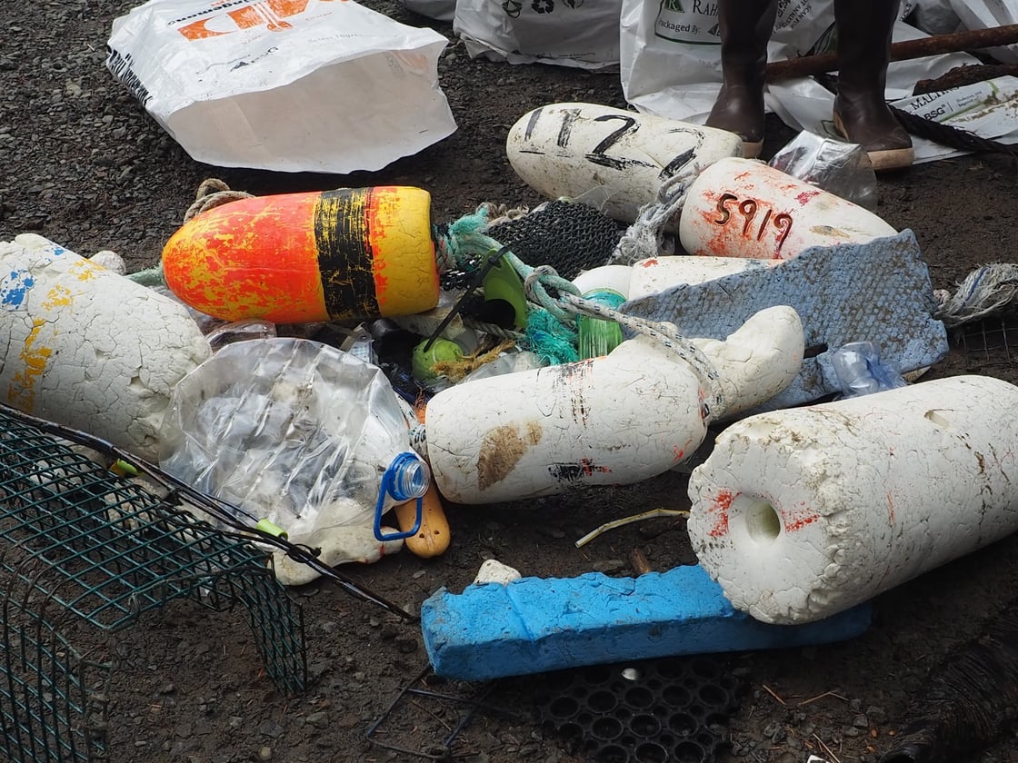 floating trash picked up by kayakers