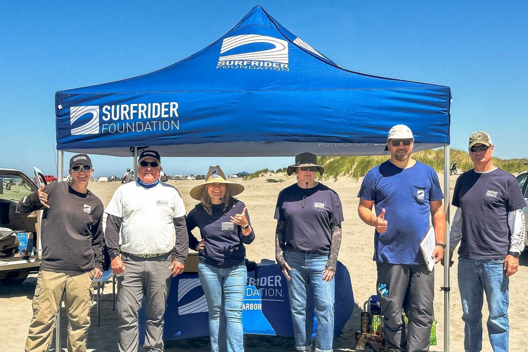 Bruce standing under a blue Surfrider tent with Surfrider Staff and the Grays Harbor Executive Committee