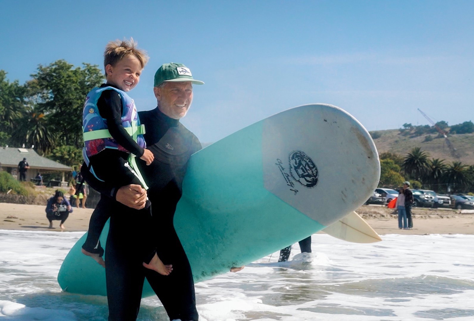 A dad and son ready to surf together
