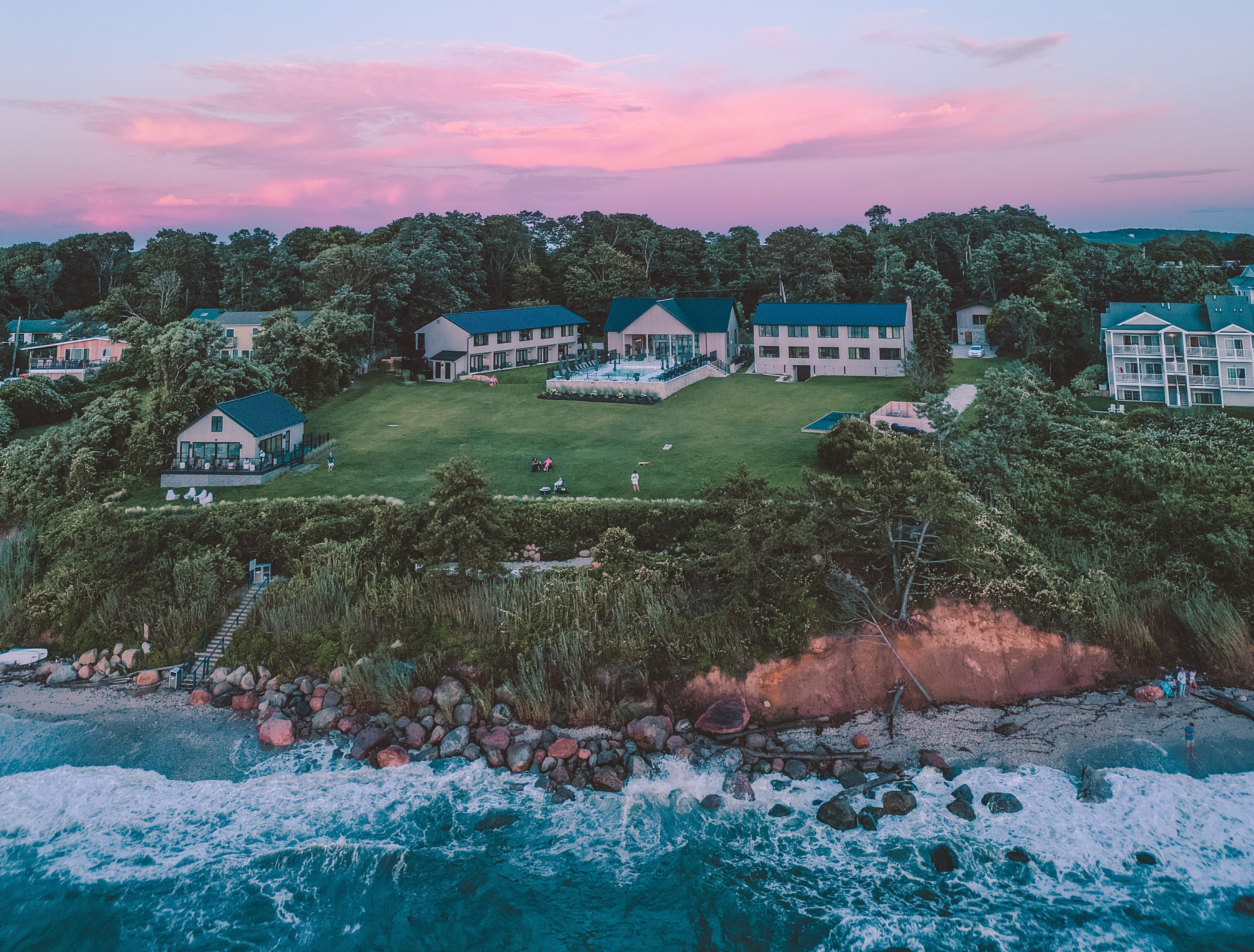 The Hotel Moraine sits on a cliff with a sunset behind it