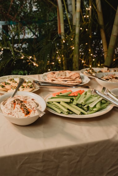 A table with different Mediterranean food plates.