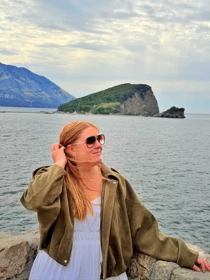 Ellen Johnson, Sustainability & Innovation Manager for prAna, looking to the side and standing in front of the ocean