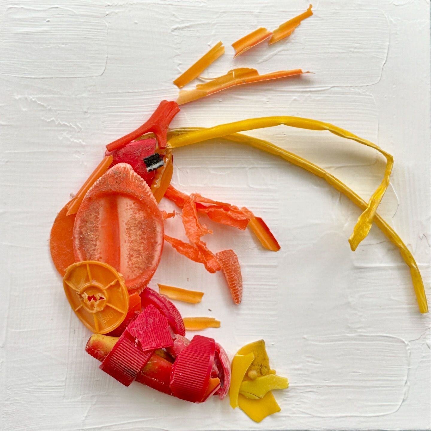 Orange shrimp made out of pieces of plastic trash.