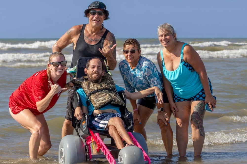 Tommy poses with a participant at the Make Promises Happen Surf Camp.