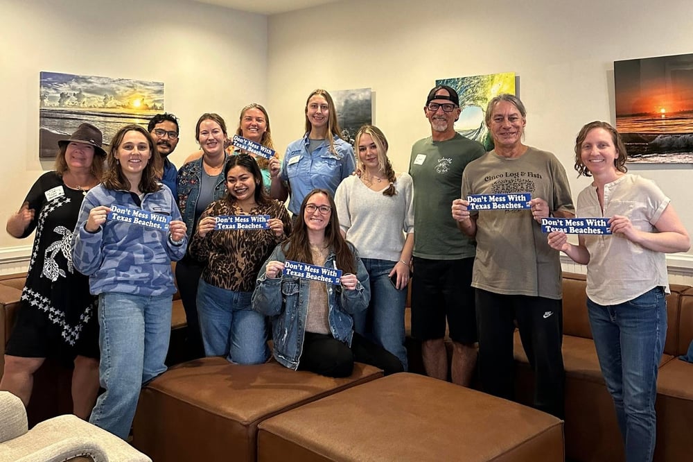 The Coastal Bend Chapter pose with stickers that read, "Don't Mess with Texas Beaches."