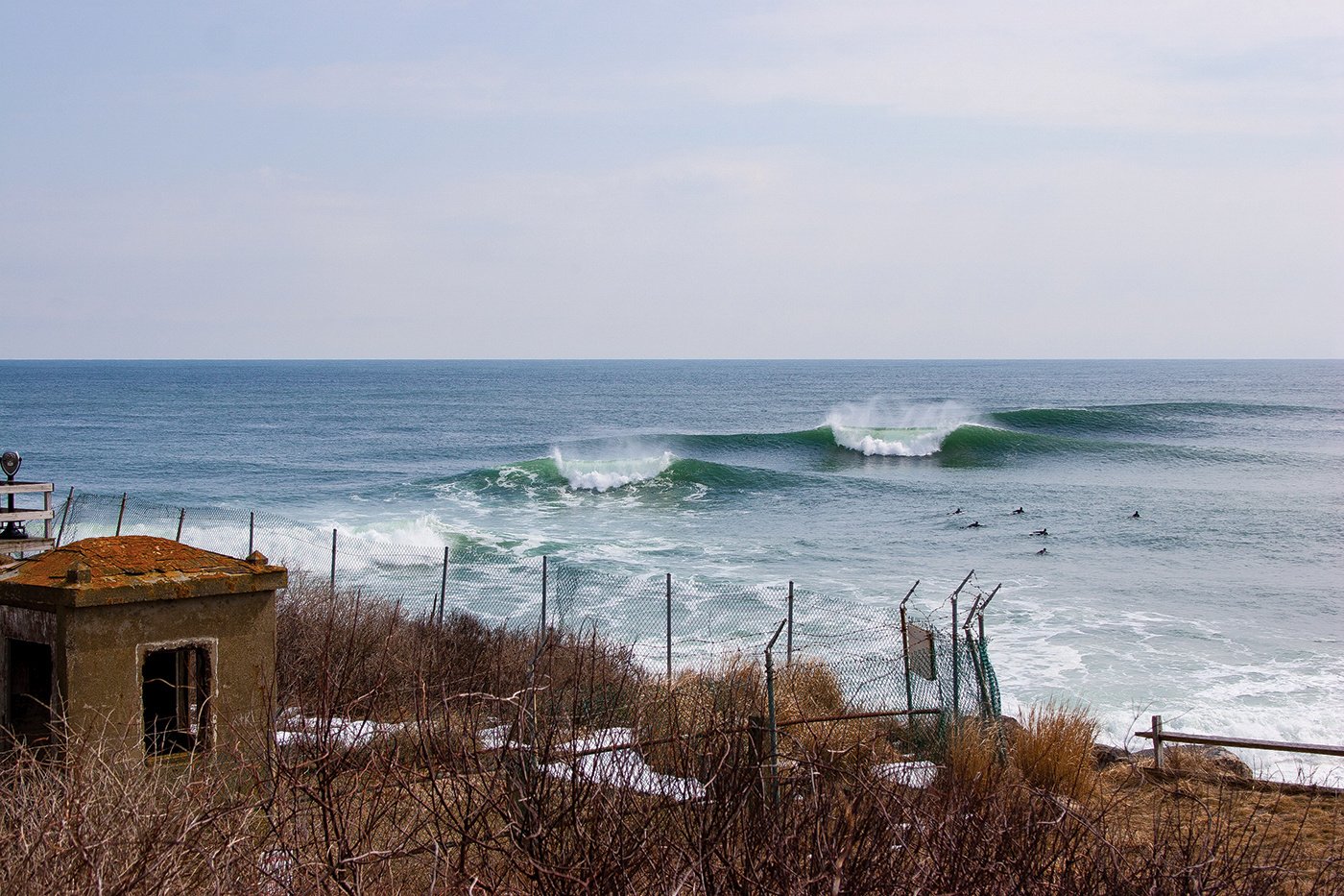 A set of waves stacks up and breaks as surfers paddle out in Montauk.