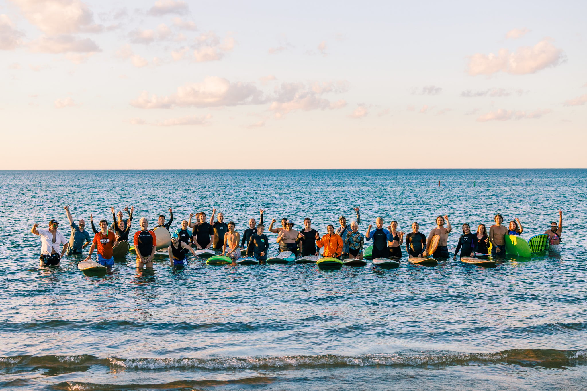 Surfrider Chicago members celebrating 17 years of legal surfing at Montrose Beach. Photo credit: Joe Siwak.