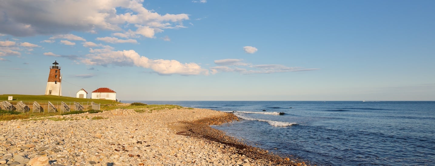 Rhode Island coast with beach and lighthouse on the left and ocean on the right